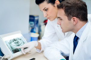 dentists looking at an x-ray Dental Care Center