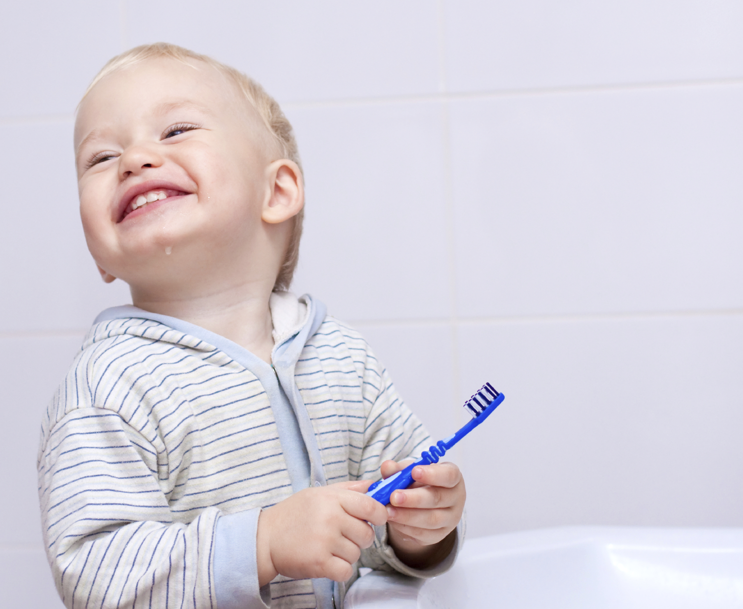 child smiling with toothbrush Dental Care Center