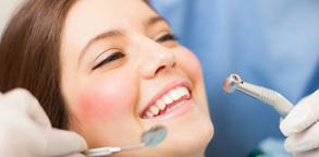 girl smiling with dental tools Dental Care Center