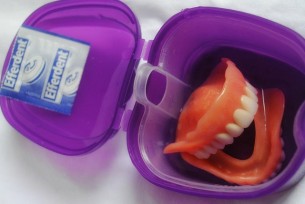 dentures in container Dental Care Center