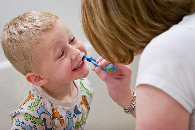 mom brushing child's teeth Dental Care Center