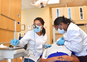 dentists applying dental sealants to a patient's teeth