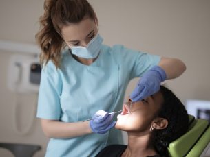 female patient getting her teeth cleaned by a hygienist