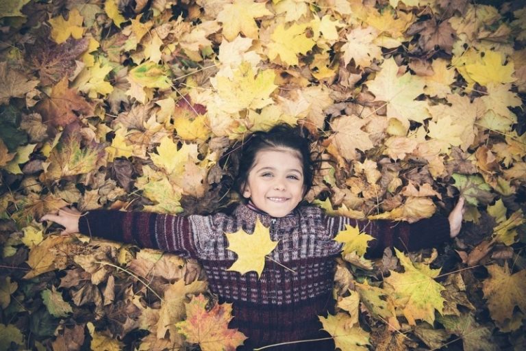 kid in leaves Dental Care Center