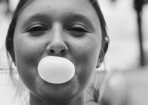 girl blowing bubble with gum
