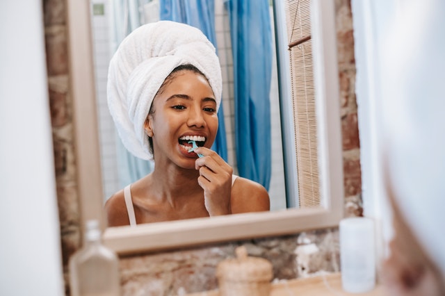 woman brushing her teeth