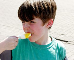 kid eating popsicle Dental Care Center
