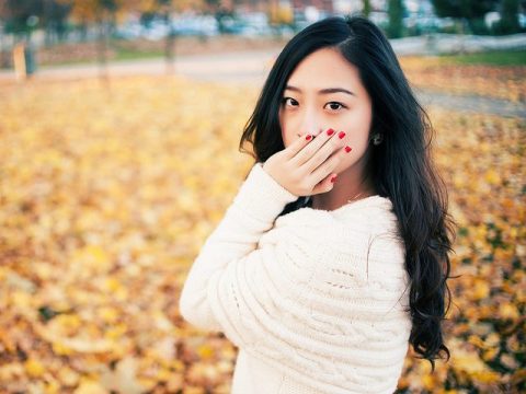 girl covering mouth Dental Care Center