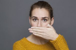 girl covering mouth Dental Care Center