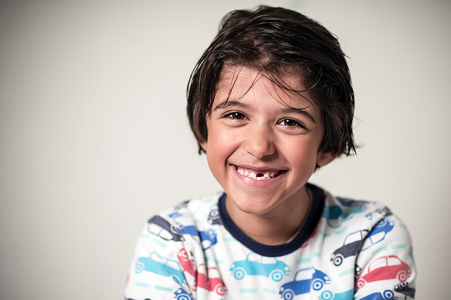 boy smiling with a tooth missing Dental Care Center